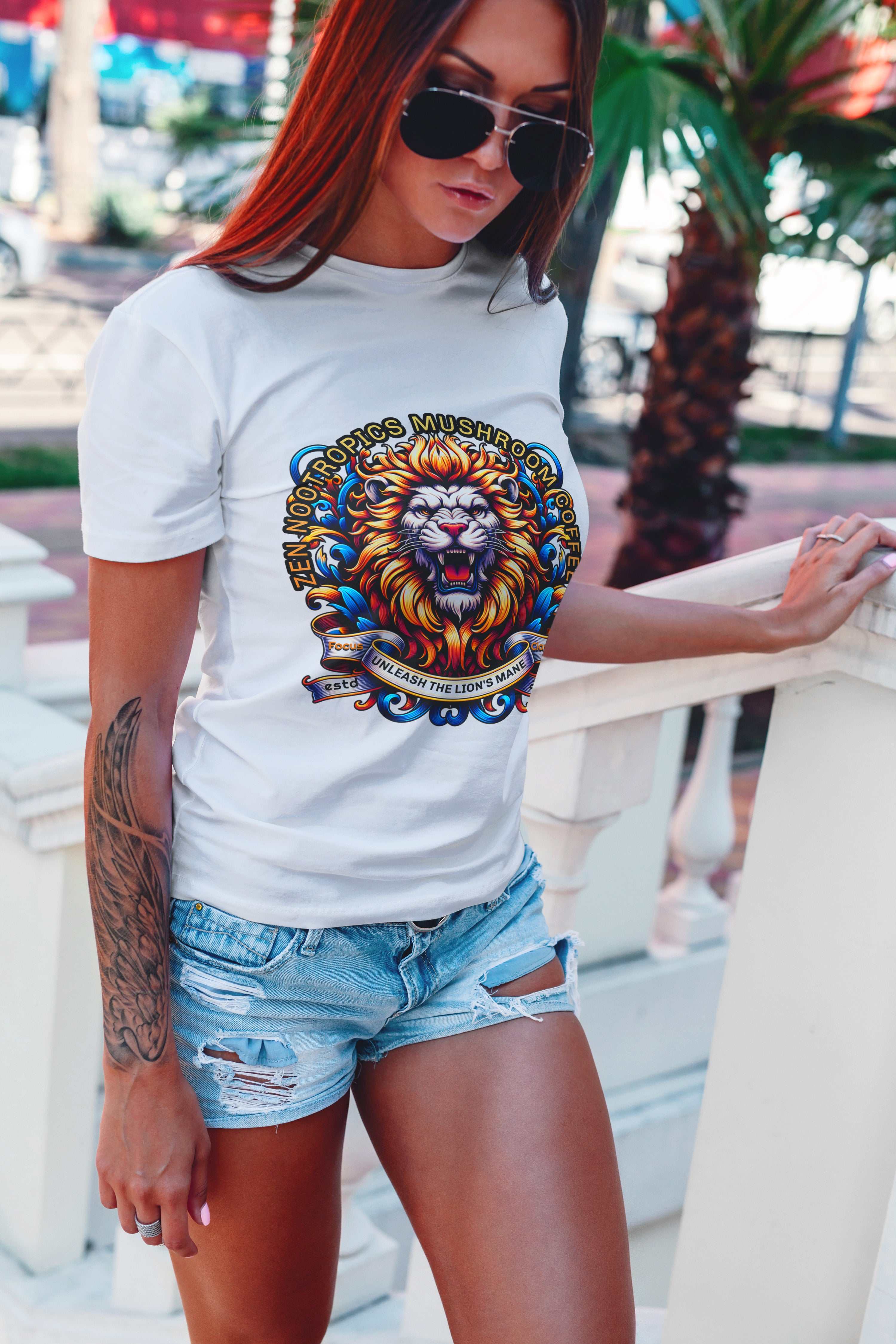 Woman wearing white Comfort Colors C1717 T-shirt with colorful lion's mane graphic and denim shorts outdoors Main image